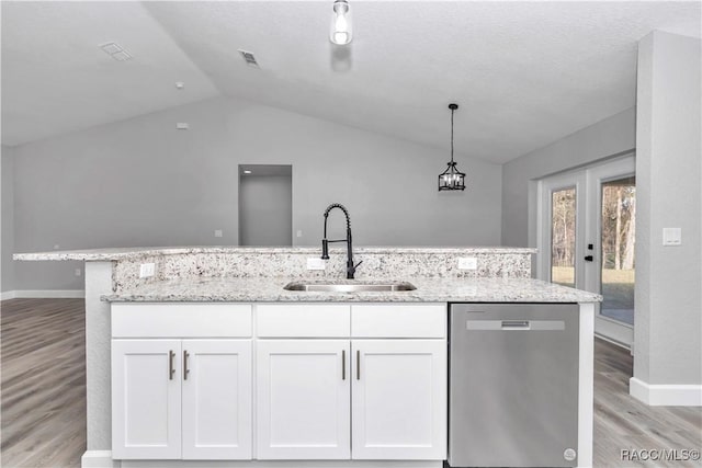 4065 SW 5th Ave, Ocala, FL 34471 - kitchen featuring vaulted ceiling, pendant lighting, white cabinetry, sink, and stainless steel dishwasher