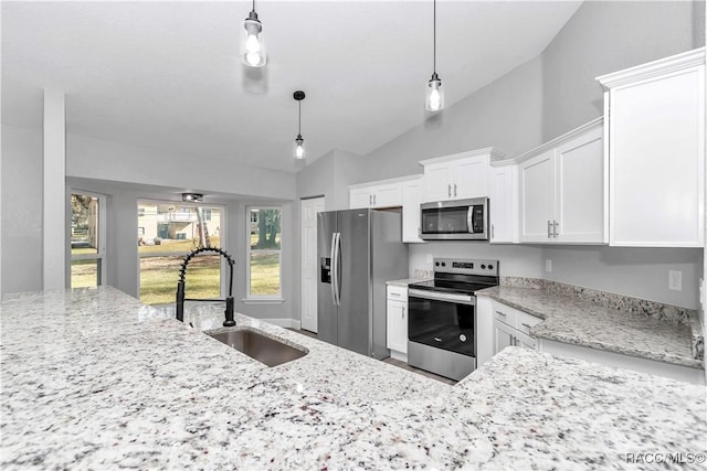 4065 SW 5th Ave, Ocala, FL 34471 - kitchen with pendant lighting, sink, appliances with stainless steel finishes, white cabinets, and vaulted ceiling