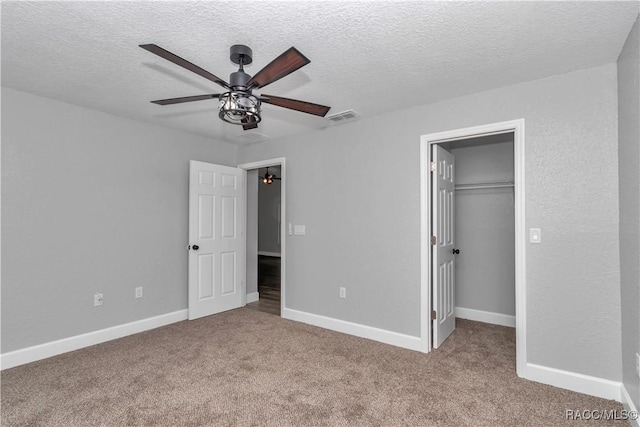 4065 SW 5th Ave, Ocala, FL 34471 - unfurnished bedroom featuring a spacious closet, light colored carpet, a textured ceiling, a closet, and ceiling fan