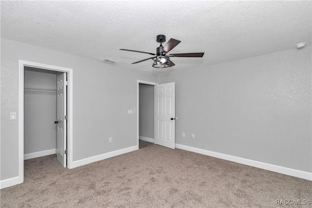 4065 SW 5th Ave, Ocala, FL 34471 - unfurnished bedroom with a closet, a spacious closet, light carpet, and a textured ceiling
