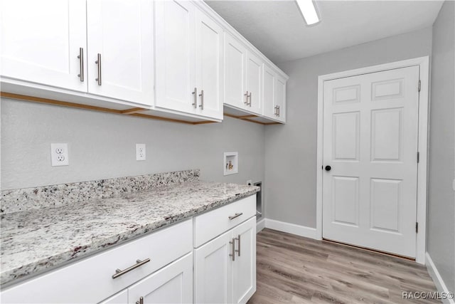4065 SW 5th Ave, Ocala, FL 34471 - laundry room featuring cabinets, hookup for a washing machine, and light hardwood / wood-style flooring