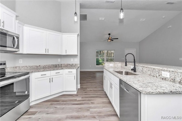 4065 SW 5th Ave, Ocala, FL 34471 - kitchen featuring white cabinetry, appliances with stainless steel finishes, sink, and pendant lighting