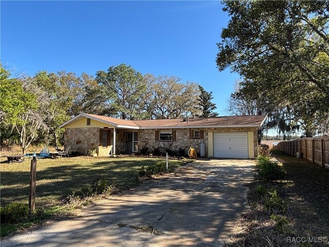 ranch-style home with a front lawn and a garage