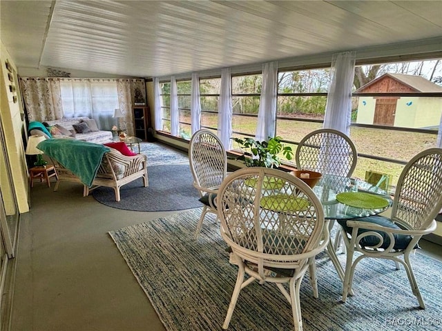 sunroom / solarium featuring lofted ceiling