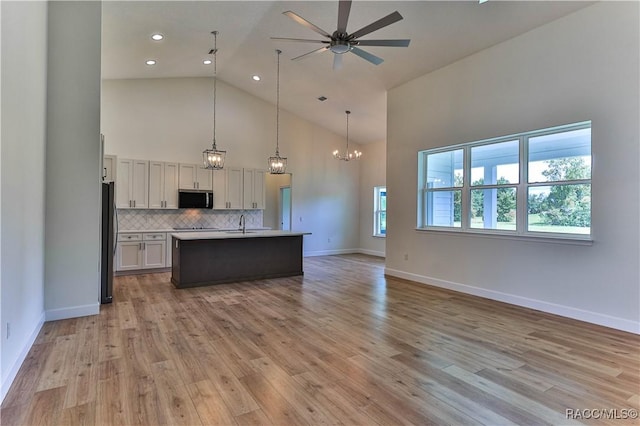 783 E Alaska Ln, Hernando, FL 34442 - kitchen with stainless steel microwave, refrigerator, open floor plan, ceiling fan, and high vaulted ceiling