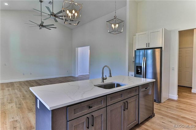 783 E Alaska Ln, Hernando, FL 34442 - kitchen with high vaulted ceiling, stainless steel appliances, a chandelier, ceiling fan, and light wood finished floors