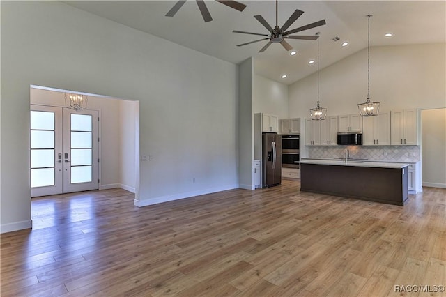 783 E Alaska Ln, Hernando, FL 34442 - kitchen featuring appliances with stainless steel finishes, open floor plan, high vaulted ceiling, a chandelier, and french doors