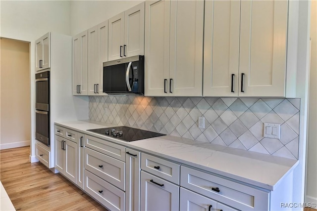 783 E Alaska Ln, Hernando, FL 34442 - kitchen with appliances with stainless steel finishes, light wood finished floors, light stone countertops, and tasteful backsplash