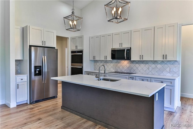 783 E Alaska Ln, Hernando, FL 34442 - kitchen with appliances with stainless steel finishes, a chandelier, high vaulted ceiling, backsplash, and decorative light fixtures