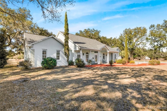 ranch-style house with a porch and a front lawn