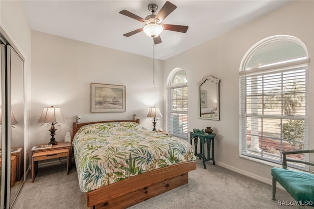 carpeted bedroom featuring a closet and ceiling fan