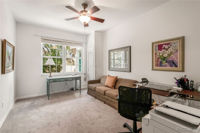 carpeted home office featuring ceiling fan