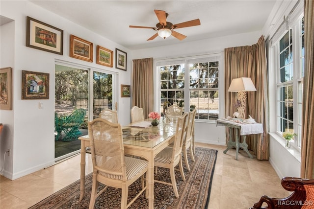 tiled dining room featuring ceiling fan