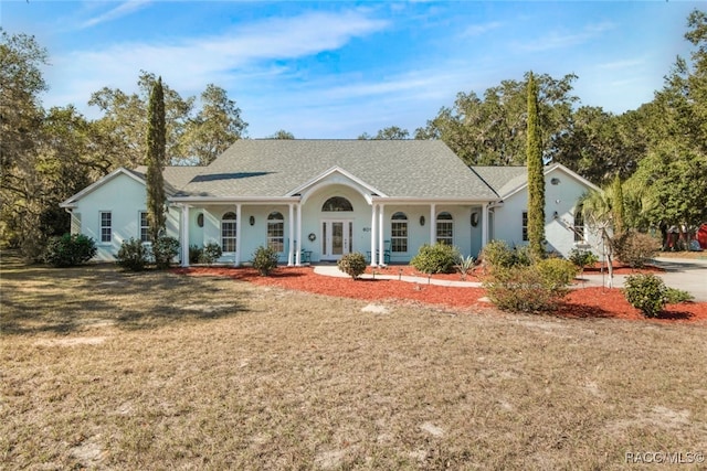 ranch-style home with a front yard and covered porch