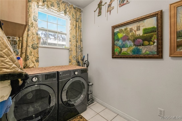 laundry area featuring light tile patterned flooring and washing machine and dryer