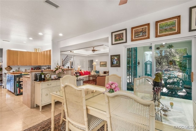 tiled dining space with ceiling fan