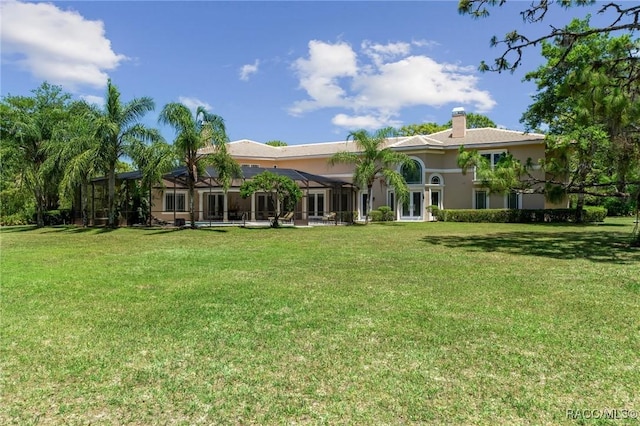 4160 W Bonanza Dr, Beverly Hills, FL 34465 - rear view of house featuring a yard, a chimney, stucco siding, and french doors