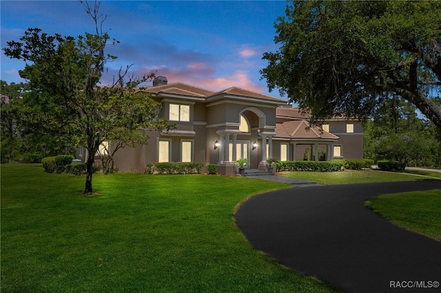 4160 W Bonanza Dr, Beverly Hills, FL 34465 - mediterranean / spanish-style home with stucco siding, a yard, and a chimney