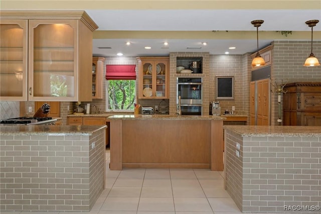 4160 W Bonanza Dr, Beverly Hills, FL 34465 - kitchen with stainless steel double oven, light tile patterned floors, gas stovetop, light stone counters, and recessed lighting
