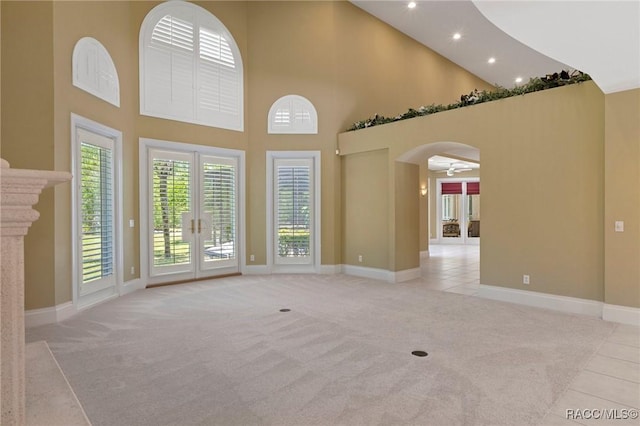 4160 W Bonanza Dr, Beverly Hills, FL 34465 - unfurnished living room with light carpet, high vaulted ceiling, plenty of natural light, baseboards, and a ceiling fan