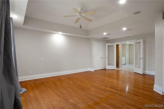4160 W Bonanza Dr, Beverly Hills, FL 34465 - empty room with a tray ceiling, baseboards, recessed lighting, light wood-style floors, and ceiling fan