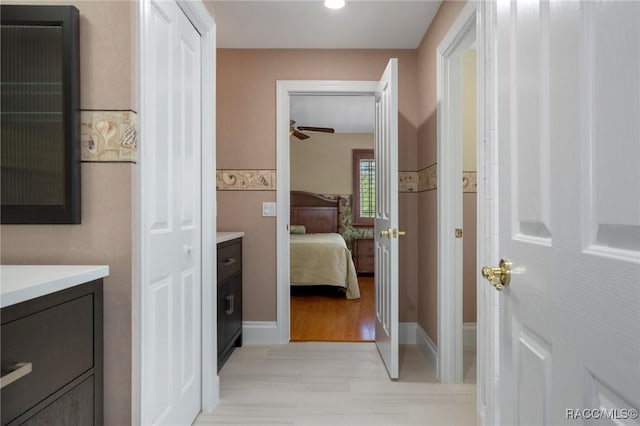 4160 W Bonanza Dr, Beverly Hills, FL 34465 - ensuite bathroom featuring vanity, a ceiling fan, wood finished floors, recessed lighting, and baseboards