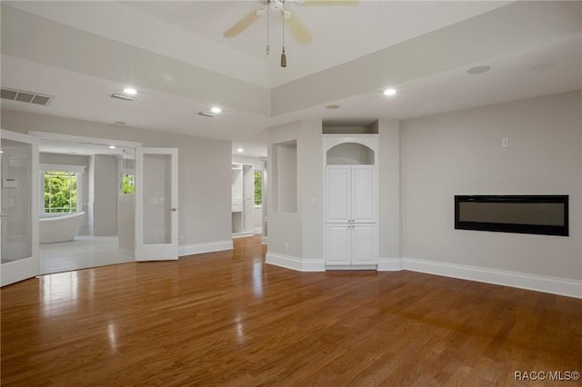 4160 W Bonanza Dr, Beverly Hills, FL 34465 - unfurnished living room with wood finished floors, baseboards, ceiling fan, recessed lighting, and a glass covered fireplace