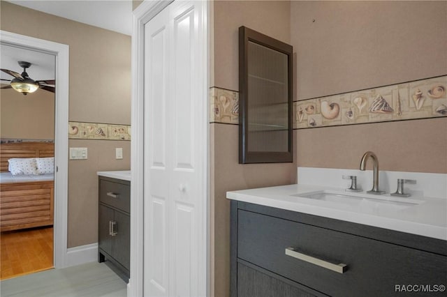 4160 W Bonanza Dr, Beverly Hills, FL 34465 - ensuite bathroom with vanity, ceiling fan, and wood finished floors