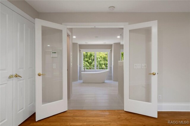 4160 W Bonanza Dr, Beverly Hills, FL 34465 - hall with french doors, wood finished floors, recessed lighting, and baseboards