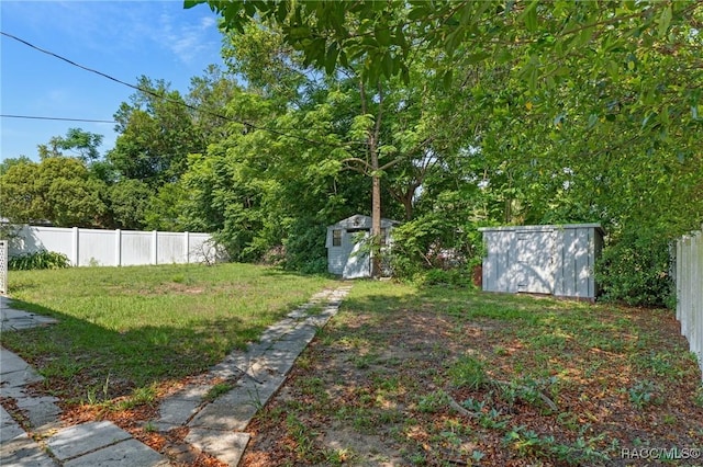 view of yard featuring a shed and an outbuilding