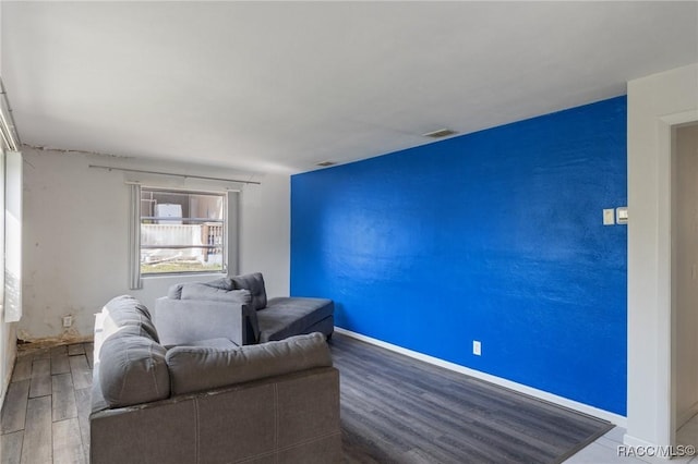 living area featuring wood finished floors and baseboards
