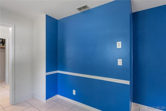 unfurnished room with tile patterned floors and baseboards