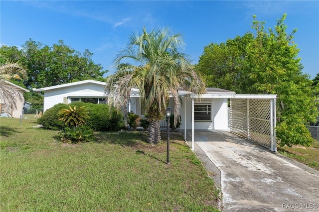 view of front facade with concrete driveway and a carport