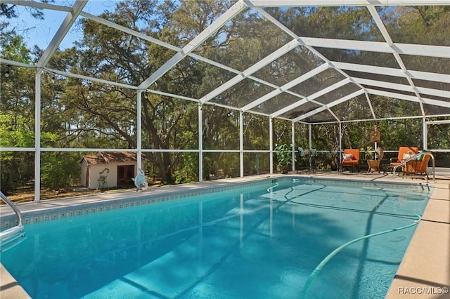 pool with a lanai and an outbuilding