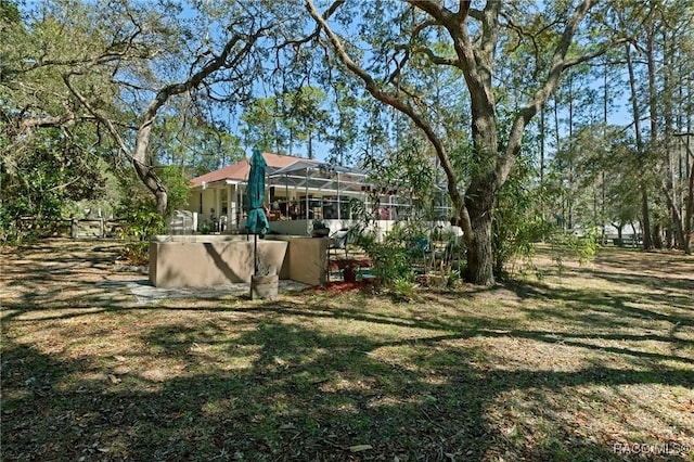 view of yard featuring a lanai