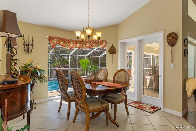 dining area featuring a sunroom, baseboards, and light tile patterned flooring