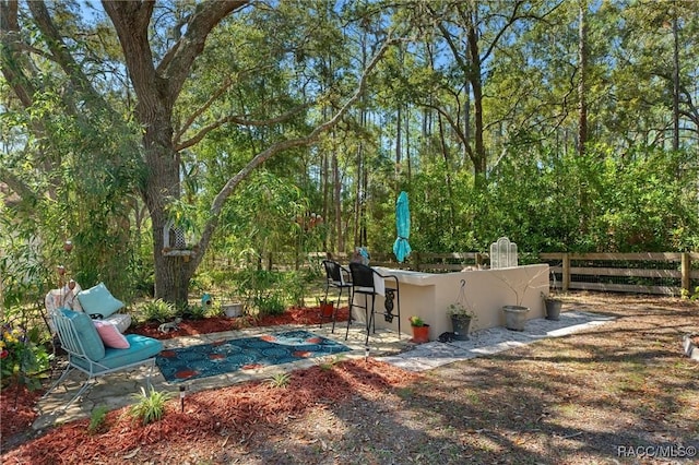 view of yard featuring a patio area and fence