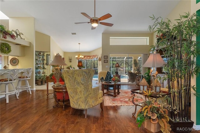 living room with ceiling fan with notable chandelier, wood finished floors, and lofted ceiling