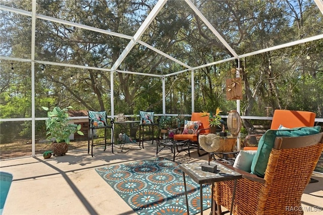 view of patio with glass enclosure and outdoor lounge area