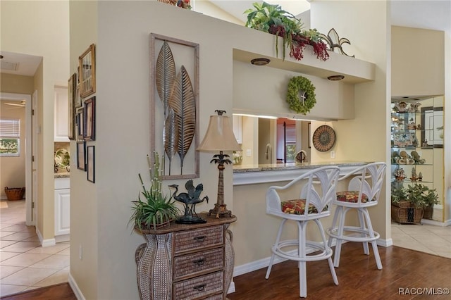 interior space with baseboards and light tile patterned floors