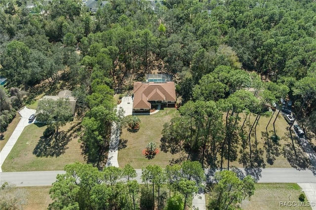 drone / aerial view with a wooded view