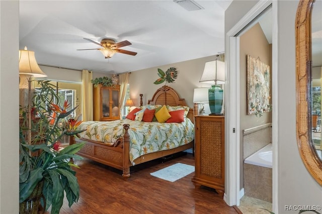 bedroom featuring wood finished floors, visible vents, and a ceiling fan