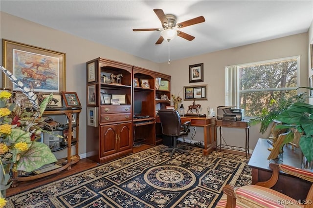 office featuring ceiling fan and baseboards