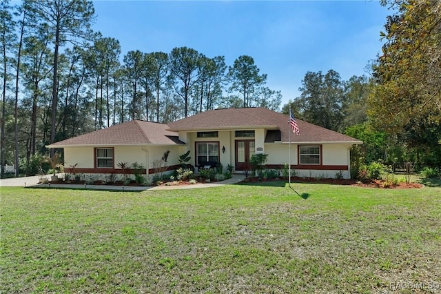 view of front of home with a front yard and stucco siding