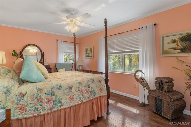 bedroom with baseboards, multiple windows, wood finished floors, and crown molding