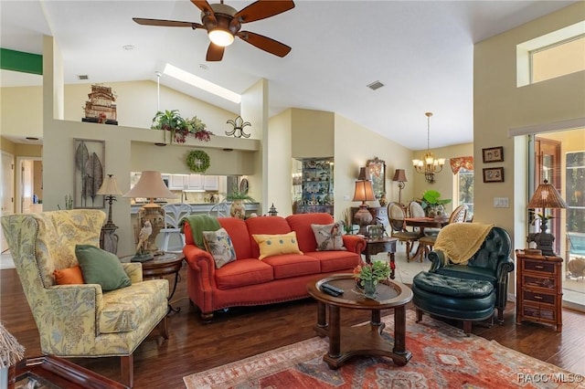 living area featuring high vaulted ceiling, visible vents, wood finished floors, and ceiling fan with notable chandelier