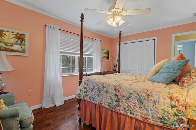 bedroom featuring a ceiling fan, baseboards, ornamental molding, a closet, and dark wood finished floors