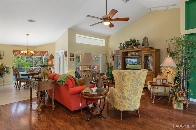 living area featuring visible vents, wood finished floors, rail lighting, high vaulted ceiling, and ceiling fan with notable chandelier