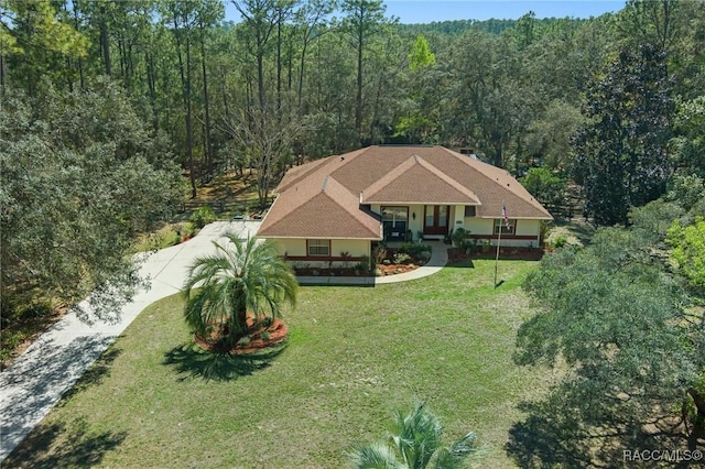 birds eye view of property with a forest view