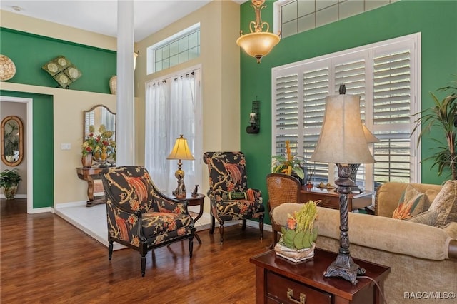 living area with baseboards and wood finished floors